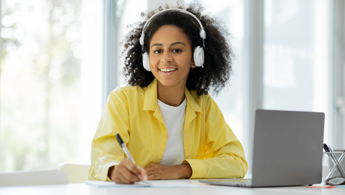 Mujer joven sonriendo con computador en aprendizaje corporativo